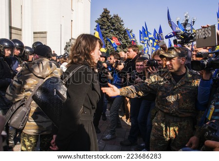 KIEV , UKRAINE - October 14, 2014: Clashes near Verkhovna Rada. The former head of the anti-corruption committee Tatyana Chornovil stands between the radicals and the police to prevent a collision.
