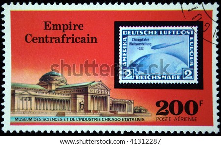 CENTRAL AFRICAN EMPIRE - CIRCA 1977: A stamp printed in Central African Empire (in present time Republic) shows postage stamp of airship on background of Museum of Sciense and industry Chicago, USA, circa 1977
