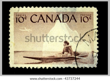 CANADA - CIRCA 1955: A stamp printed in the Canada shows Eskimo in kayak floats on the sea on the background of the iceberg above him flies a plane, circa 1955