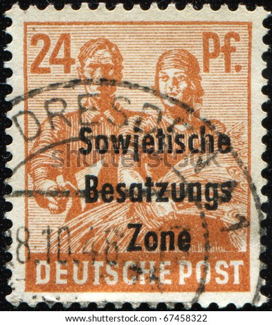 GERMANY - CIRCA 1946: A  Soviet occupation zone stamp printed in Germany shows worker with a trowel in hand and the peasant woman with a sheaf of wheat, circa 1946
