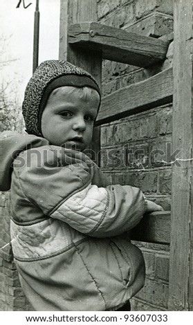 little boy climbs the wooden stairs, mounted on a brick wall, Kamensk Shakhtinsky, Rostov Region, USSR, 1980