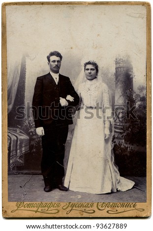 RUSSIA - CIRCA end of the XIX - the beginning of XX century: An antique photo shows bride and groom, the village Petropavlovsk now Severouroalsk Russian text: photography studio Russian light painting