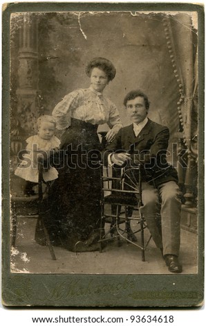RUSSIA - CIRCA end of XIX - beginning of XX century: An antique photo shows married couple with girl, Volchansk, Kharkov Province, Russia, now Ukraine Russian text: Maksimov (photographer), Volchansk