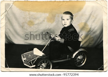USSR - CIRCA 1960s: The little boy on the pedal car, circa 1960s