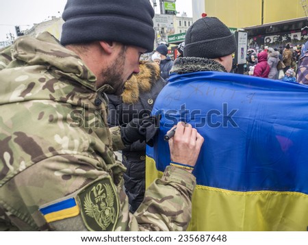 KIEV, UKRAINE - December 6, 2014: Soldiers volunteer signs on the national flag of Ukraine. -- More than 100 soldiers of the battalion of territorial defense \