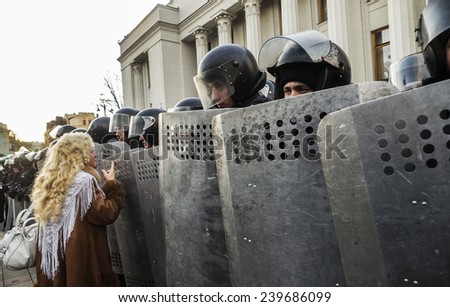 KIEV, UKRAINE - December 23, 2014: Woman talking with the National Guard. -- To break through the cordon of police and four special forces in full uniform