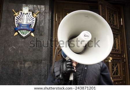 KIEV, UKRAINE - January 13, 2015: Activist with a loudspeaker in the hands against the building of the General Prosecutor\'s Office.