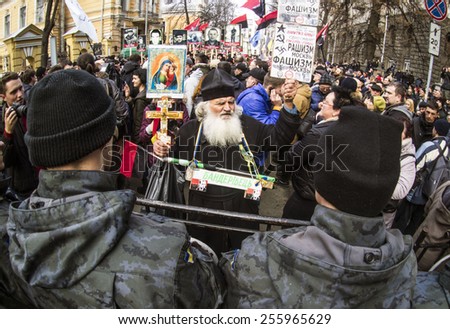 KIEV, UKRAINE - Feb 25, 2015: The priest talking with the police at a rally \