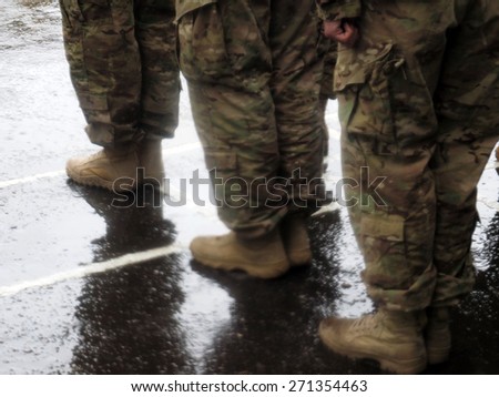 LVIV, UKRAINE - April 20, 2015; US military is listening to the President Poroshenko in the pouring rain. Military of Airborne brigade arrived from the US to Yavorovsky polygon in the Lviv region