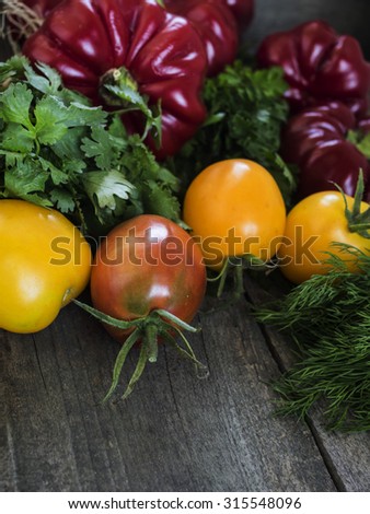 harvest of fresh vegetables on the table: pepper, tomato, spicy herbs