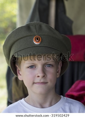 Little Caucasian boy in cap officer of the White Army during the Civil War 1917 - 1921 in the Russian Empire