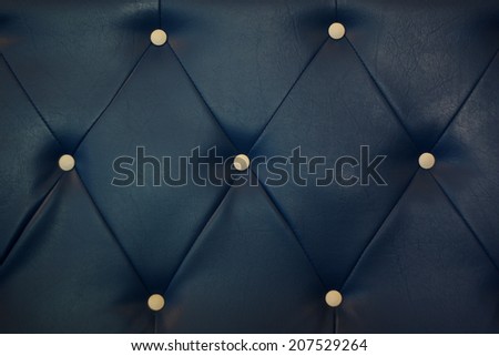 white bottoned on blue leather pattern background