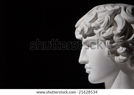 Plaster head of sculpture, black background