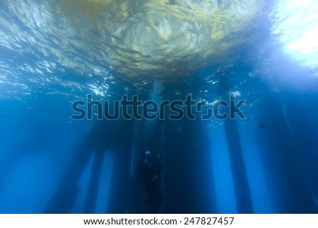 Scuba Diver at underwater Oil Rig Dive Site