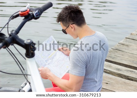One happy tourist bicyclist with route map