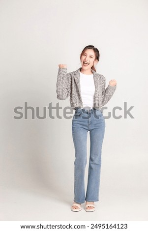 Similar – Image, Stock Photo Stylish young asian woman dressed in casual wear looking to mobile phone screen when posting photos in social media and thinking about interesting content text. Lifestyle blogger checking blog comments outdoor at autumn