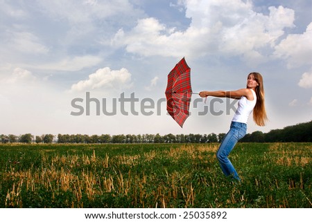 Girl with umbrella. Wind