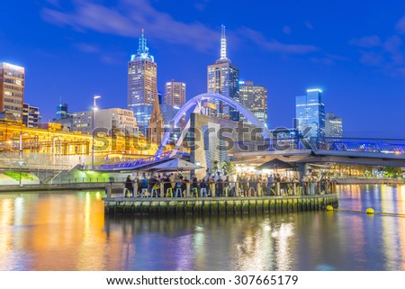 Melbourne, Australia - August 15, 2015: View of people in Ponyfish Island cafe, a restaurant bar surrounded by water, in Melbourne, Australia at twilight.