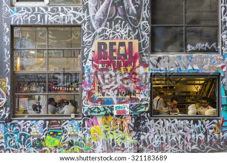 Melbourne, Australia - September 18, 2015:  View of customers and chefs in a restaurant in Hosier Lane, Melbourne. Hosier Lane is one of the city\'s best street art locations.