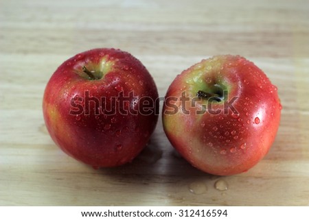 Two apples on desk