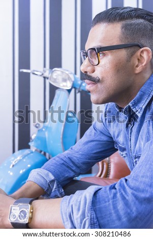 portrait of a profile of a thoughtful hairstylist at his barber shop - focus on the eye