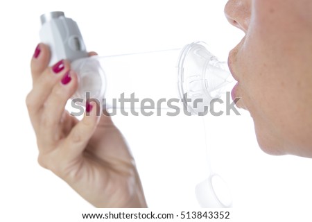 Detail of a mouth is inhaling the medicament from the pressurized cartridge inhaler placed on an inhalation chamber - Isolated on a white background Imagine de stoc © 