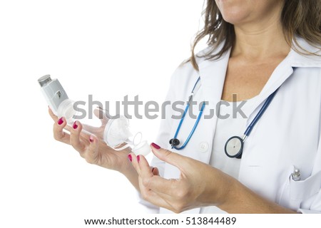 Close up of the hands of a female doctor are removing the lid of a pressurized cartridge inhaler placed on an inhalation chamber on a medical demonstration - Isolated on a white background
 Imagine de stoc © 