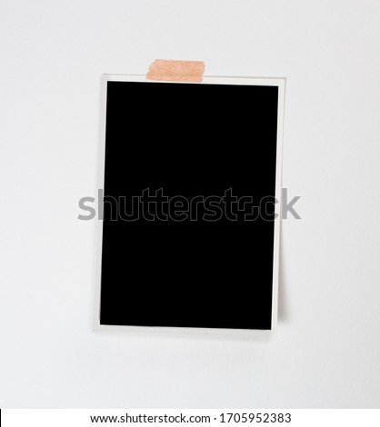 Blank polaroid photo frame with soft shadows and scotch tape isolated on white paper background as template for graphic designers presentations, portfolios etc.