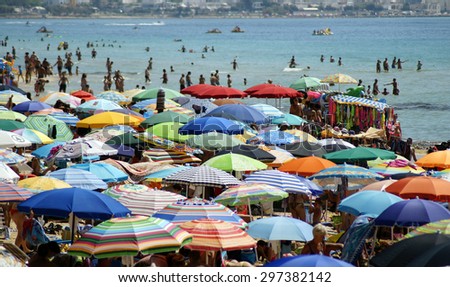 NAPLES ITALY  - September 14: Crowded beach covered with umbrellas in Naples City,  on september 8, 2014. N is a popular beach resort on the East Coast italian