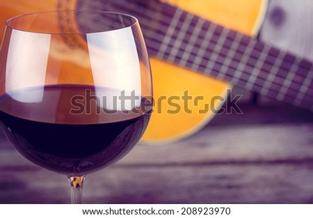Wine and Guitar on a wooden table vintage retro photo