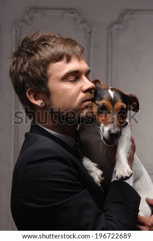 Young man hugging his jack Russell terrier dog