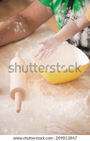 Closeup portrait of cute little girl hands cooking pastry, mixing flour  with father