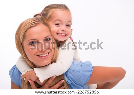 Happy family of mother holding daughter  on her back  smiling looking  at camera  isolated on white background with copy place