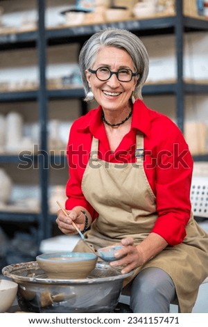 Similar – Image, Stock Photo Craftswoman painting a bowl made of clay in art studio