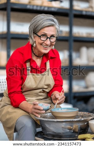 Similar – Image, Stock Photo Craftswoman painting a bowl made of clay in art studio