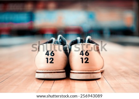 Bowling footwear. Close up of bowling shoes lying on bowling alley