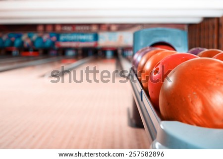 Bowling game. Closeup of bowling balls lying on bowling alley