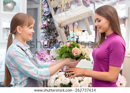 This bouquet is a sign of love and care. Florist gives a bouquet to the smiling young client