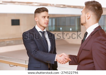 Gratitude for meeting. Two young businessmen having a handshake at the meeting