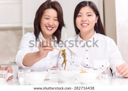 Asian tasty food. Asian mommy and daughter at home together having dinner