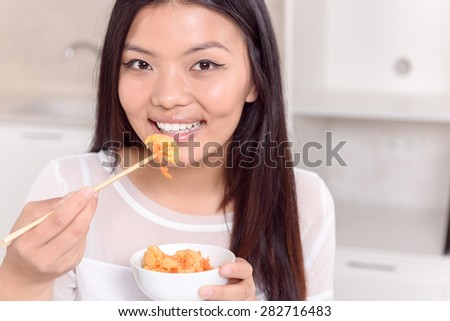 Nice girl, nice food. Pretty Asian girl posing with Asian food