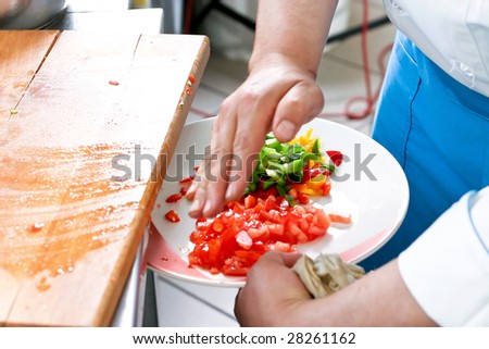 Chef cutting the vegetables on a wooden board