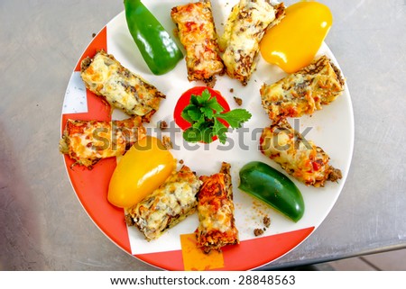 Served pancakes with meet inside, cheese and vegetables