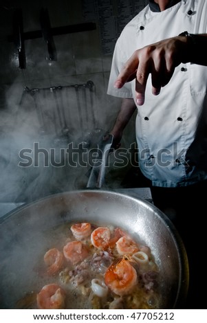 Chef prepare seafood mix for pasta