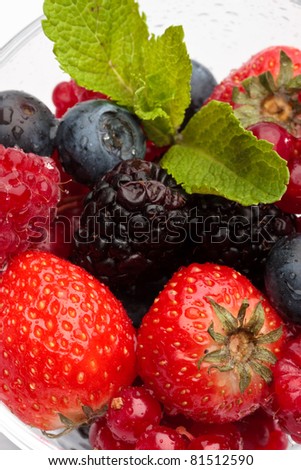 Fresh forest berries in a glass on a white background isolated