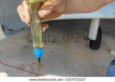 Closeup of man’s hand holding a GATS jar during preflight checklist Stock fotó © 