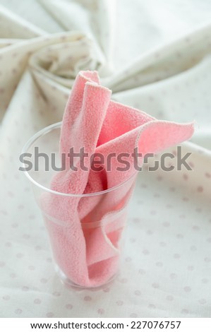 A pink micro fiber cloths in plastic glass.