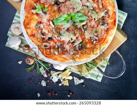 Pizza with Ham and Mushrooms on dark background