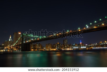New York City/Manhattan skyline in the night with the Brooklyn Bridge over the East river, shot at night on 15 June 2014.