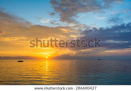 Golden sunset over a turquoise blue ocean in Maldives
